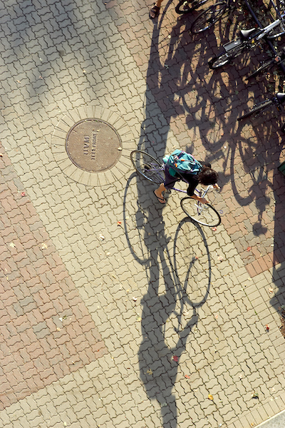 UVM student on bicycle — representing the student journey through innovation